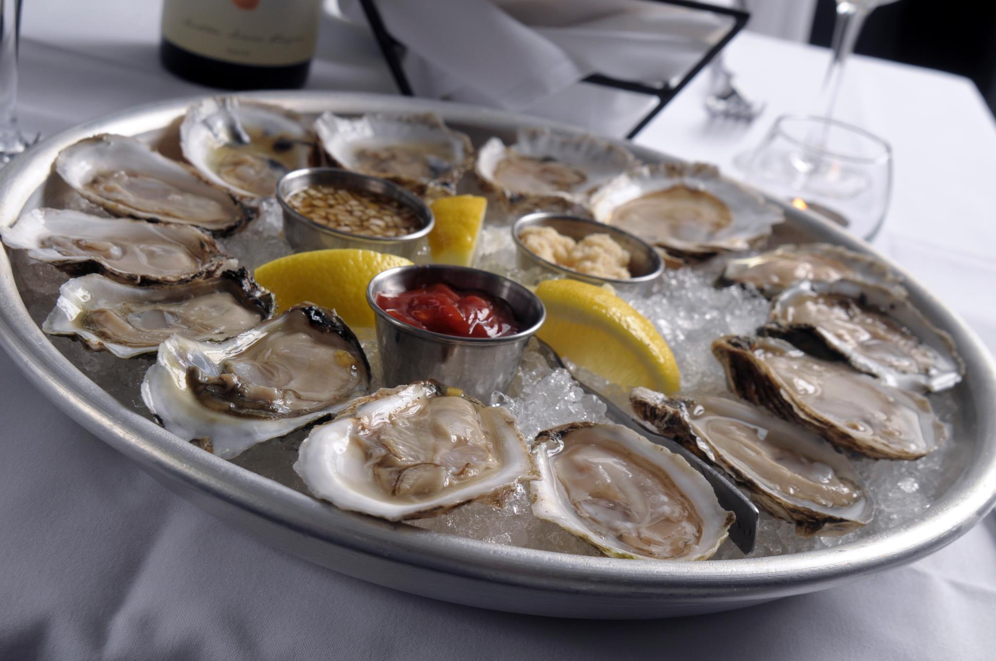 Mare Oyster Bar signature dishes Oysters on the Half ShellCrudo TastingGrilled Whole Branzino
